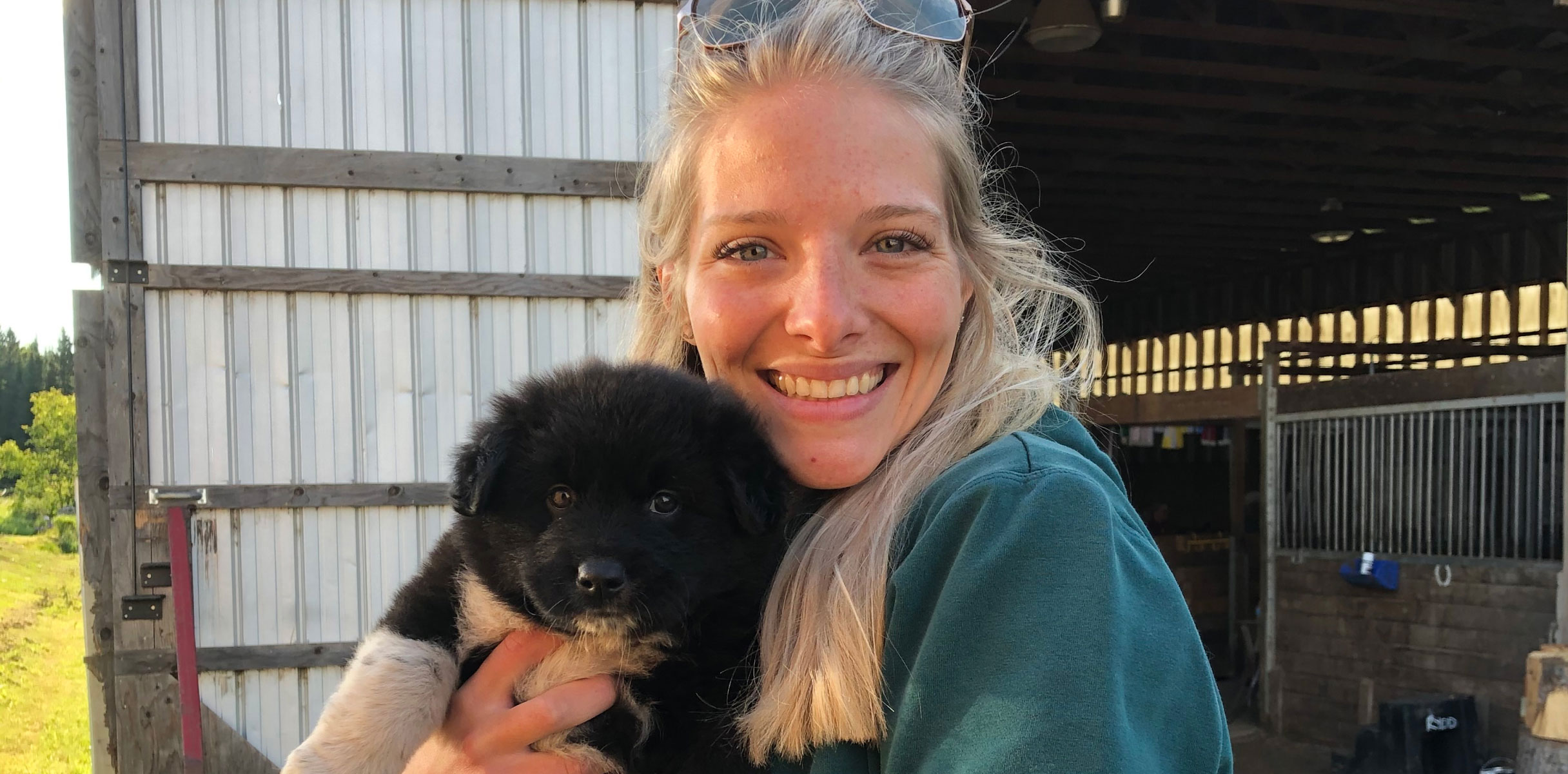 Blonde woman with black puppy