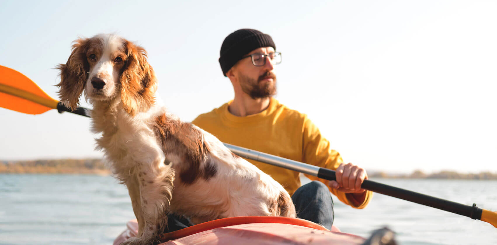 Make a splash: Safely swim, boat, and play in the water with your dog - Man in kayak with his pet dog